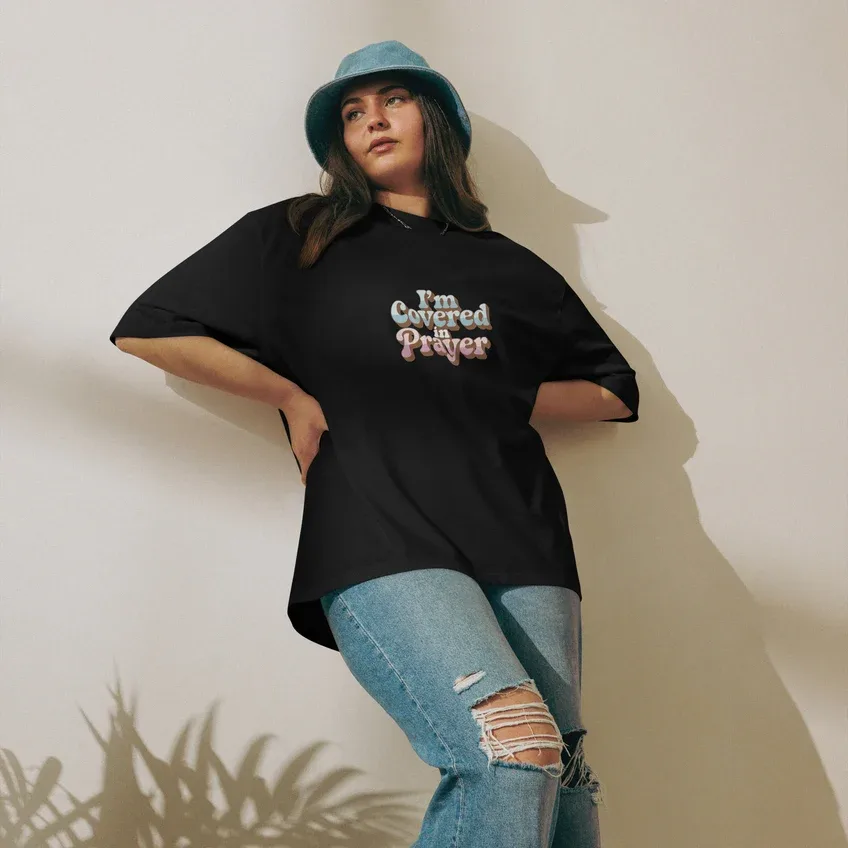 Woman wearing an I'm Covered in Prayer t-shirt